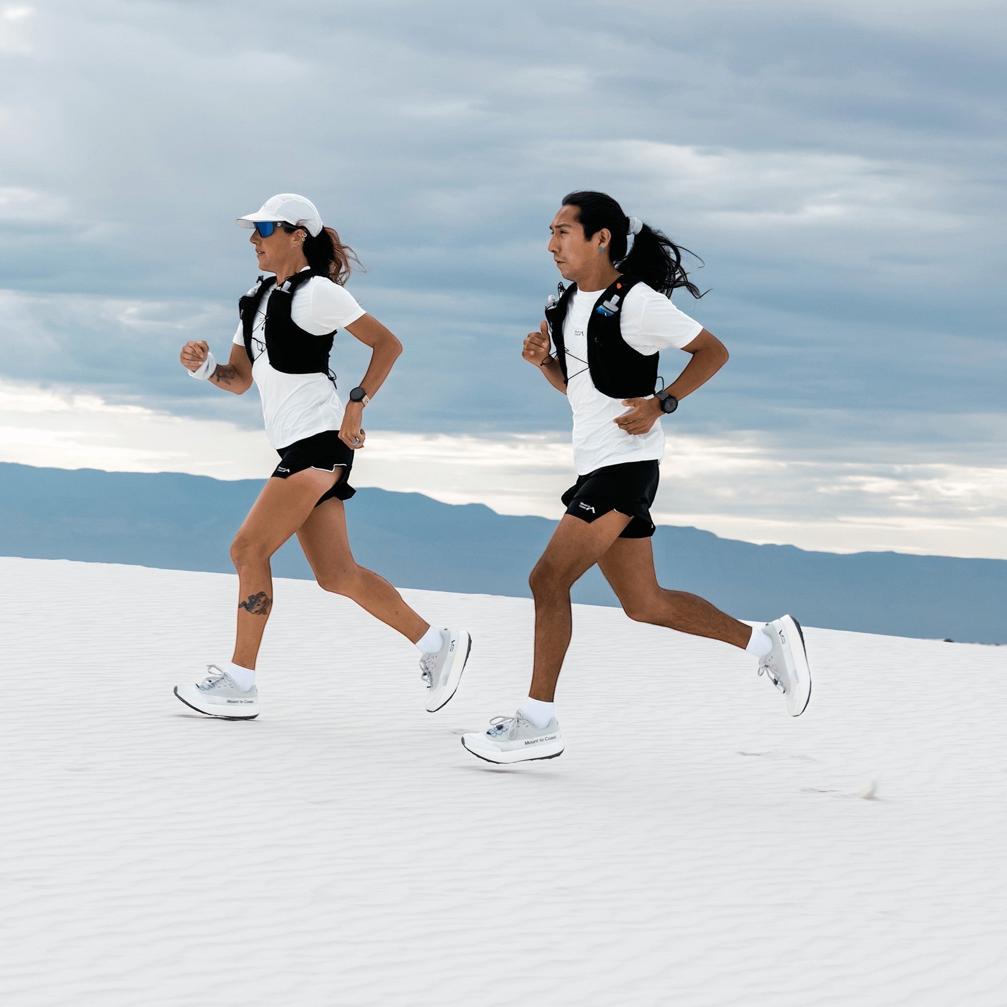 Endurance Edge H1 road-to-trail running shoes worn by two runners in white and black athletic gear